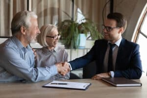 An attorney talking to a man and woman about setting up a trust