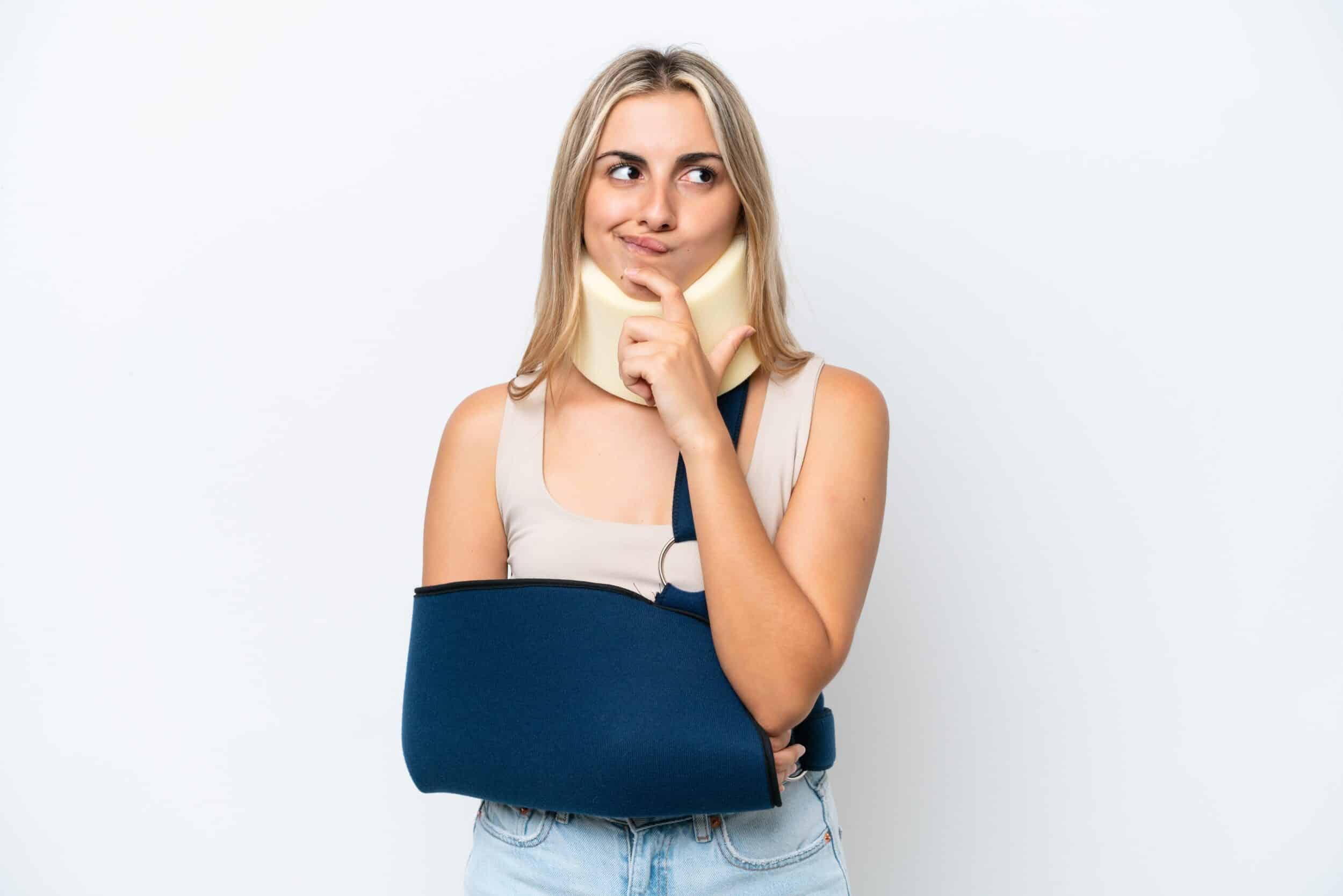 Confused woman with a neck and arm brace looking unsure of what to do about her personal injury